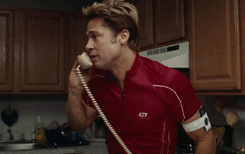 GIF of Brad Pitt answering the phone from Burn After Reading