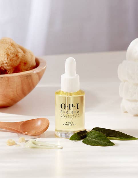 bottle of cuticle oil surrounded by ingredients