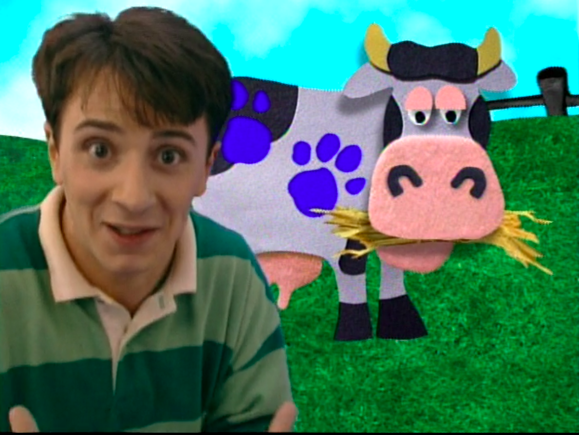 Steve in front of a cow with three clues on it