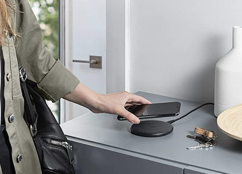 Model placing iPhone on the Anker wireless charger