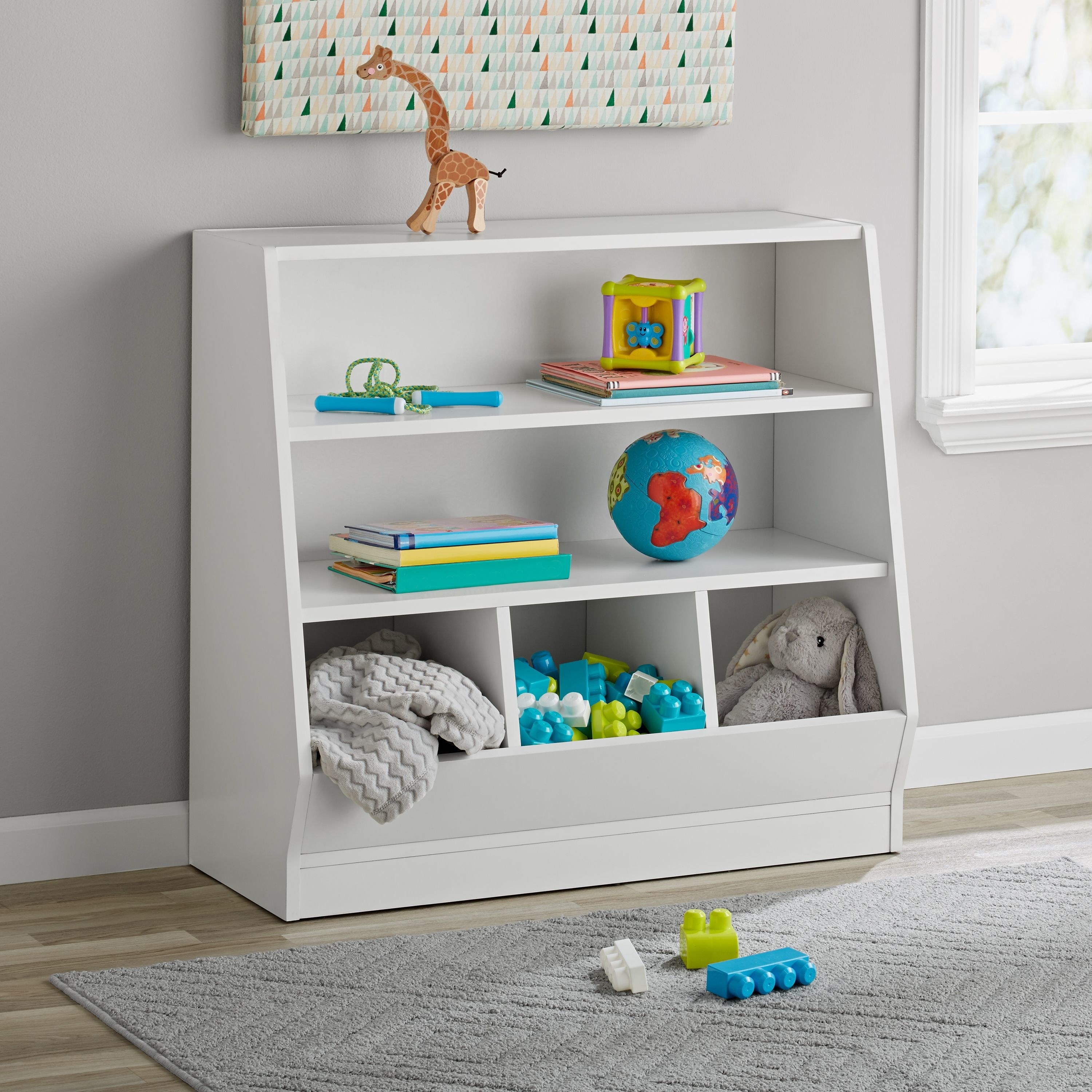 The white bookshelf and bin with toys