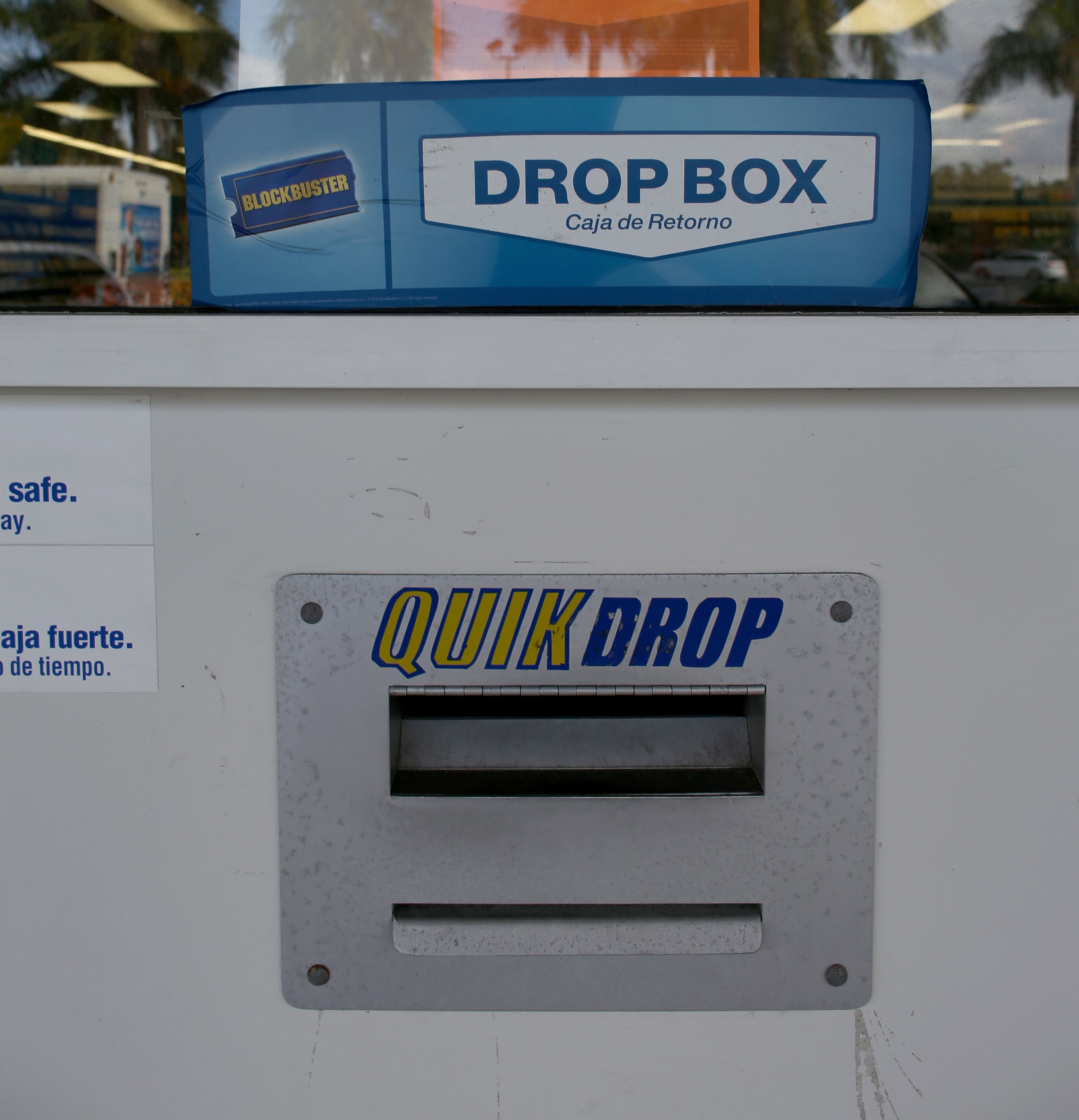 A closeup of a quick drop box outside a Blockbuster Video store