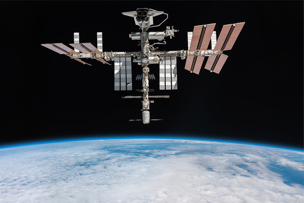 A robot-like machine floating above earth in space