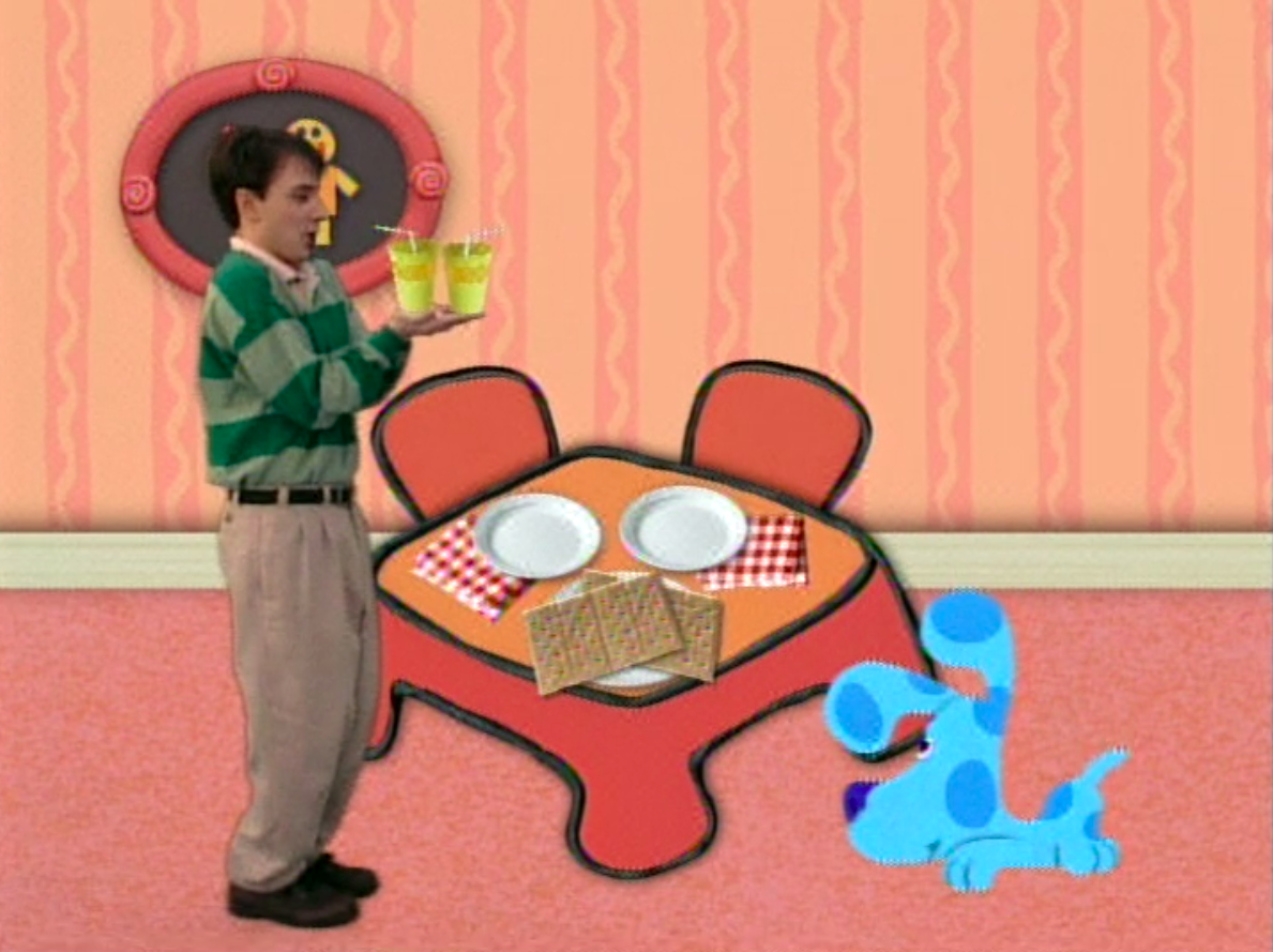 Steve bringing milk in cups with straws to the table