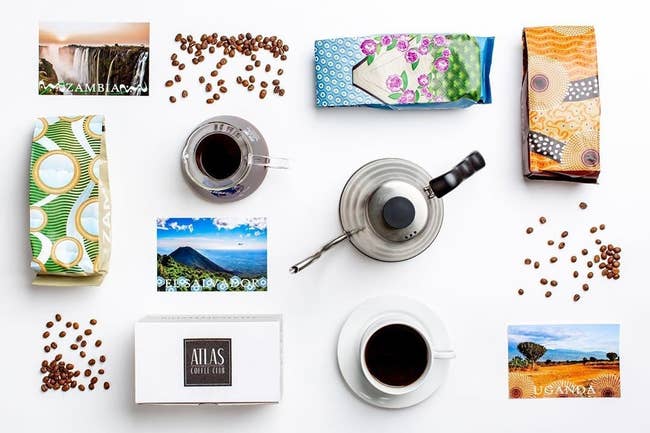 A birds eye view of the subscription box, bags of coffee, and cups of coffee spread out on table