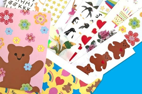Animal, food, flower, ballerina, star, heart, and letter sticker sheets coming out of a decorated envelope