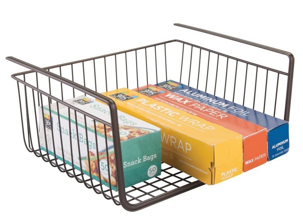 Bronze under-the-shelf basket carrying plastic wrap containers and snack baggies
