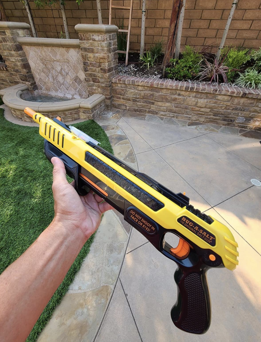 Reviewer holding the salt shooter in backyard