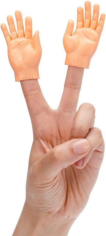 model does peace sign with two small plastic hands on fingers