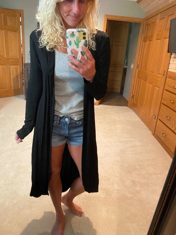 Reviewer wearing black duster cardigan