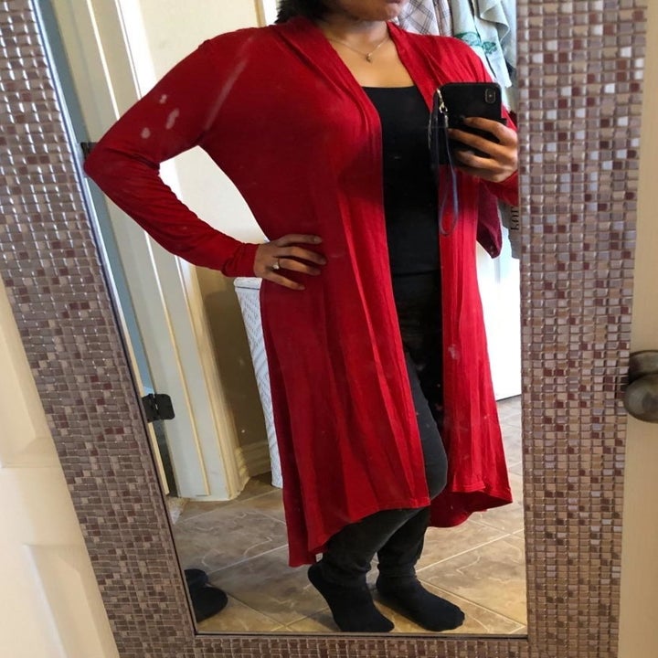 Reviewer wearing red duster cardigan