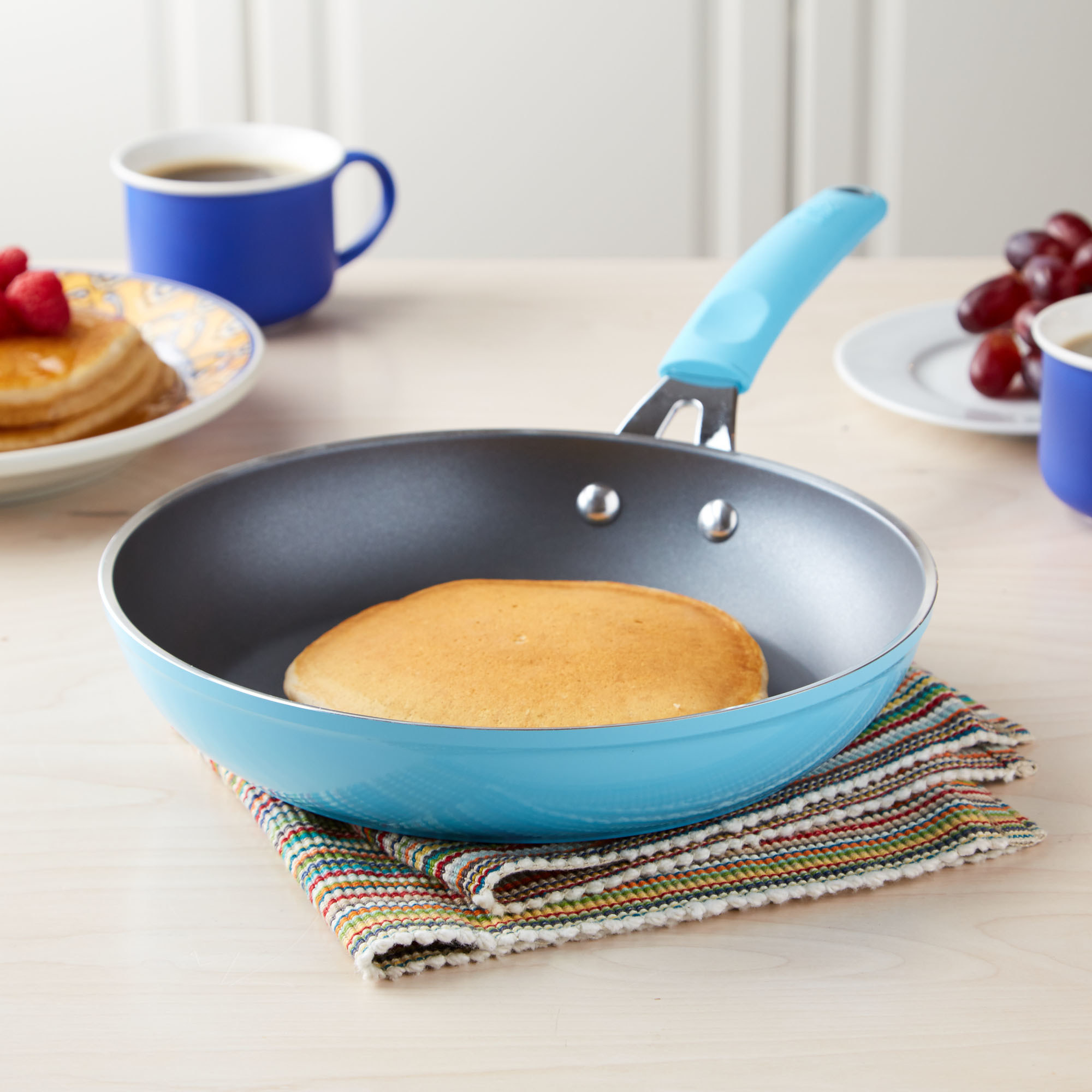 A blue skillet with a pancake in it