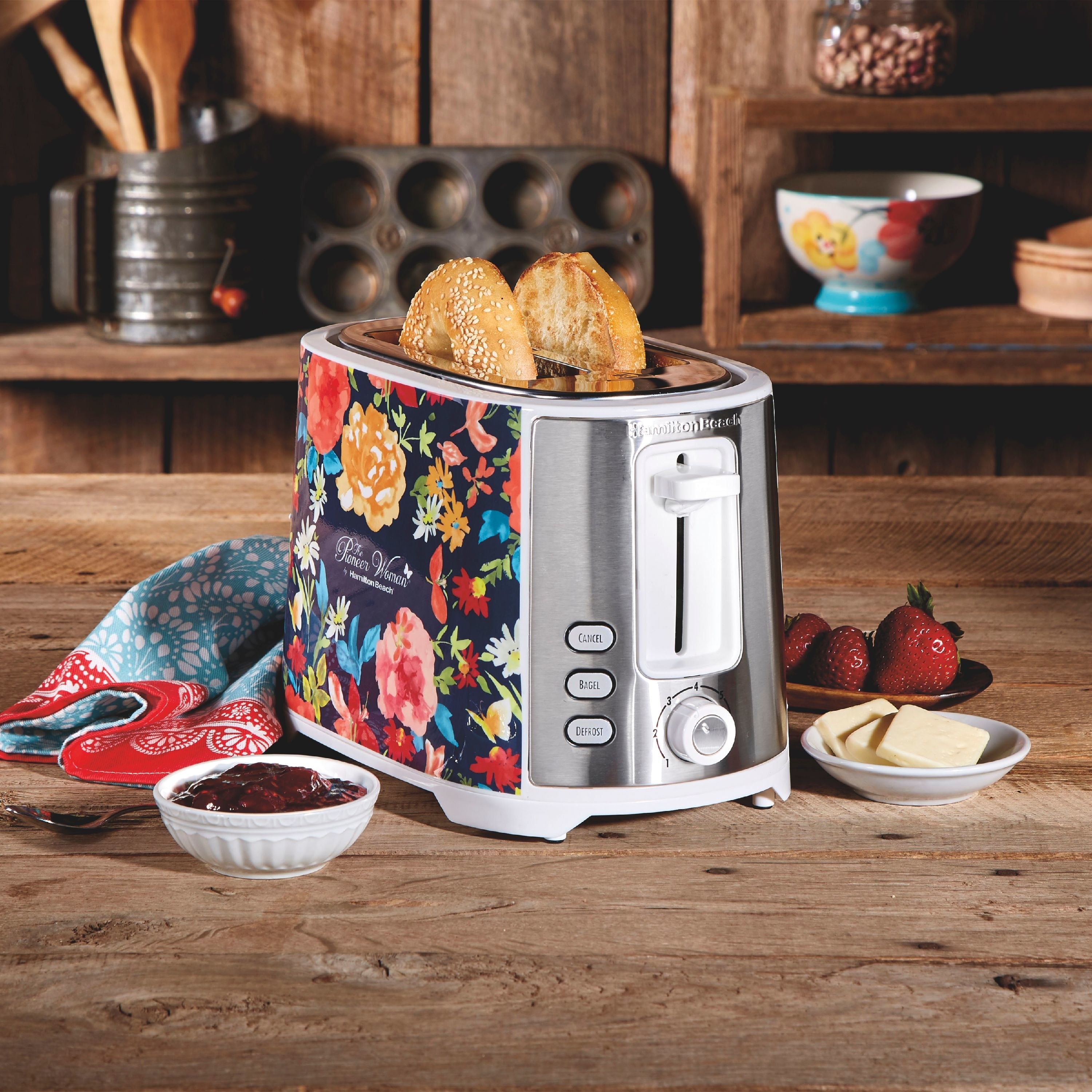 The toaster, which has two bread slots, and side panels with floral patterns