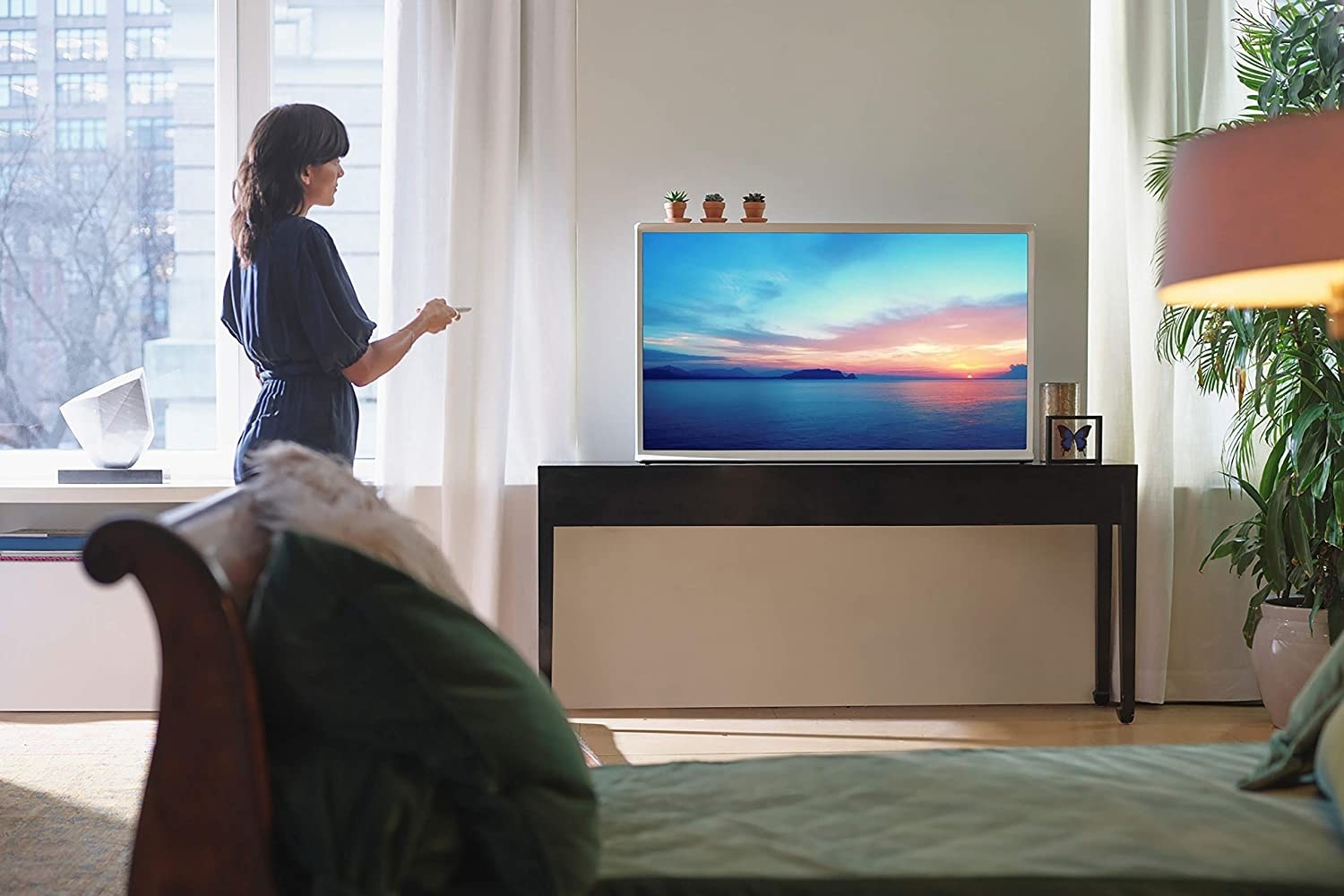 Samsung smart TV with a woman standing in front of it