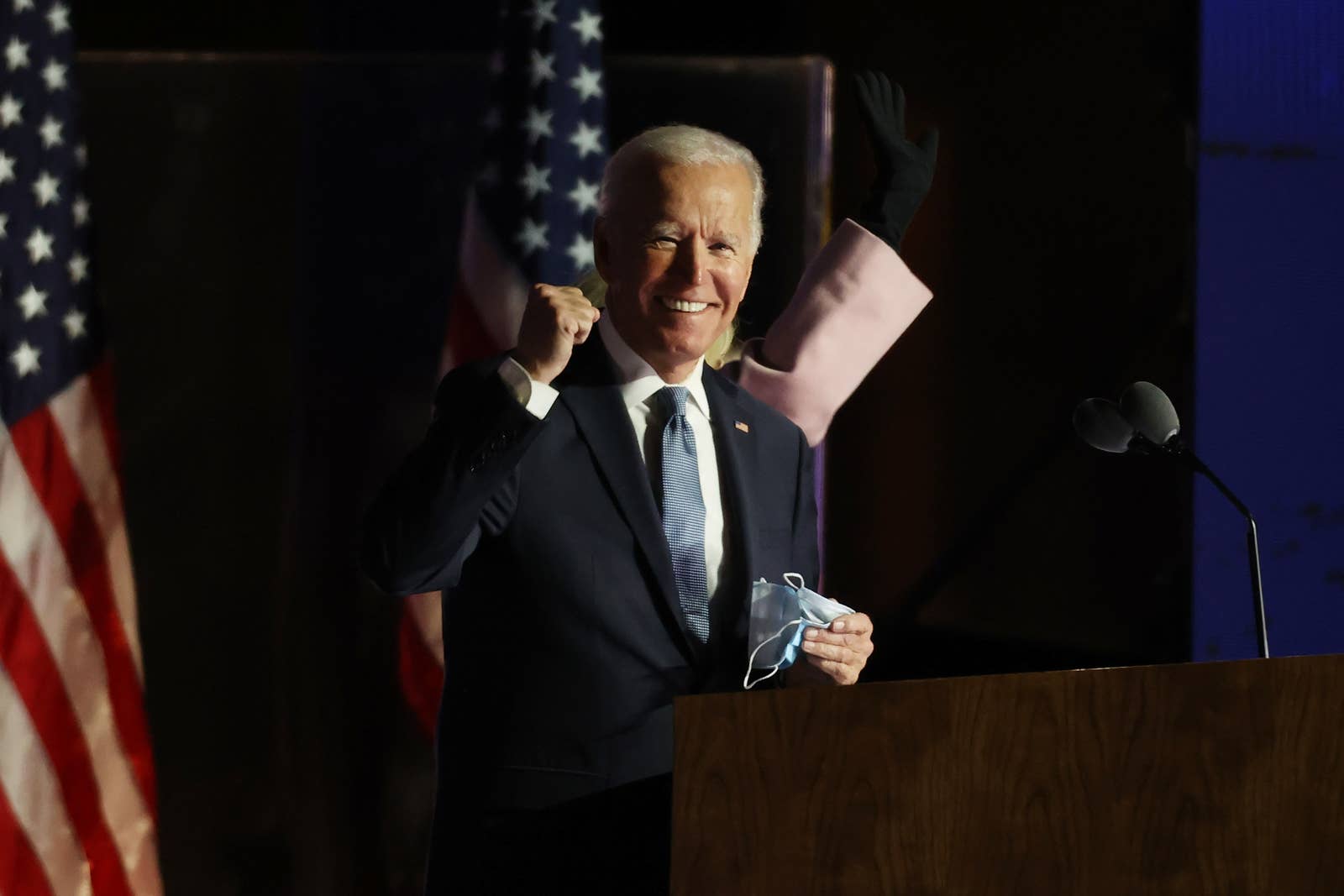 Biden pumps his fist while standing a podium