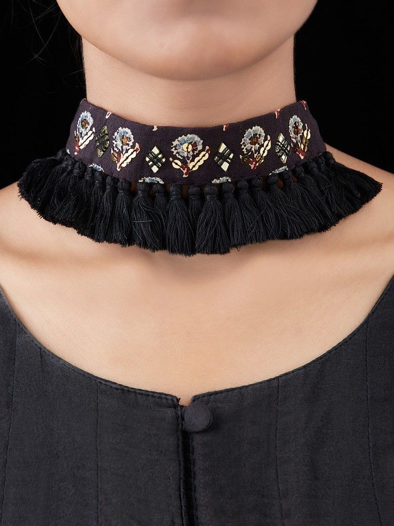 A model wears a fabric necklace