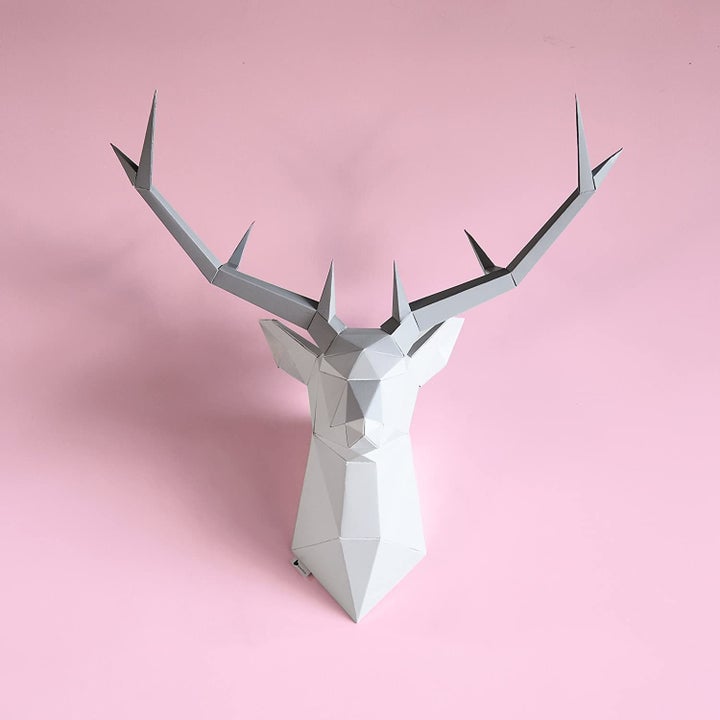 A paper wall trophy shaped like a deer displayed on a wall.