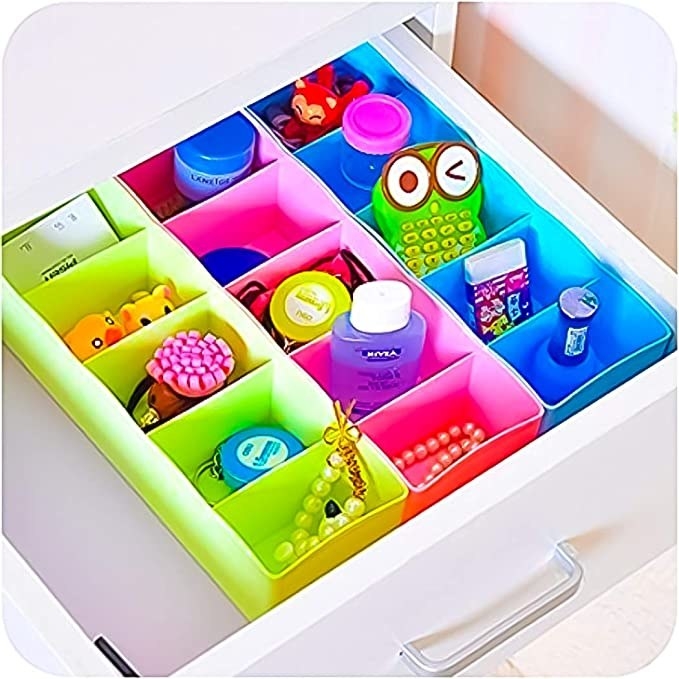 Multicoloured storage organisers with compartments.