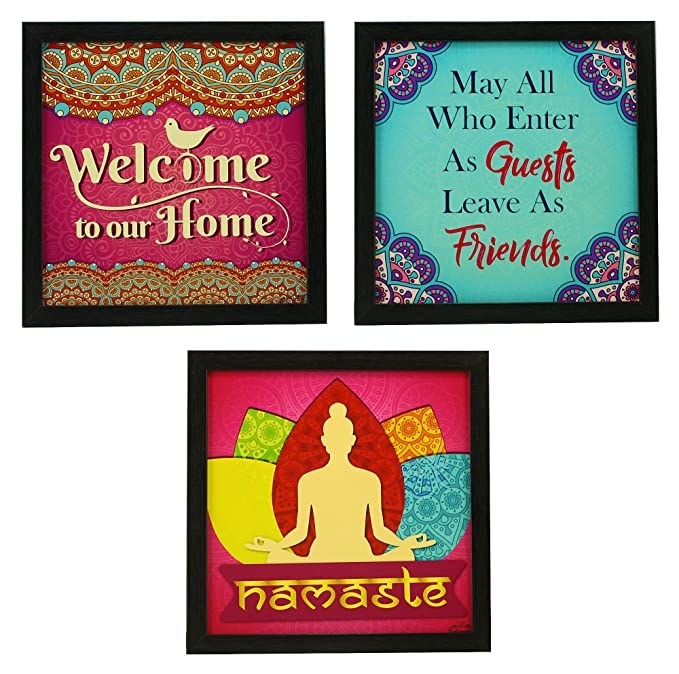 Three framed hangings - &quot;Welcome to our home,&quot; &quot;May all who enter as guests leave as friends,&quot; and a silhouette of Buddha and the text &quot;Namaste&quot; underneath it.