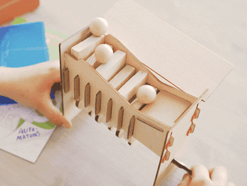 Gif of a child playing with the craft they made