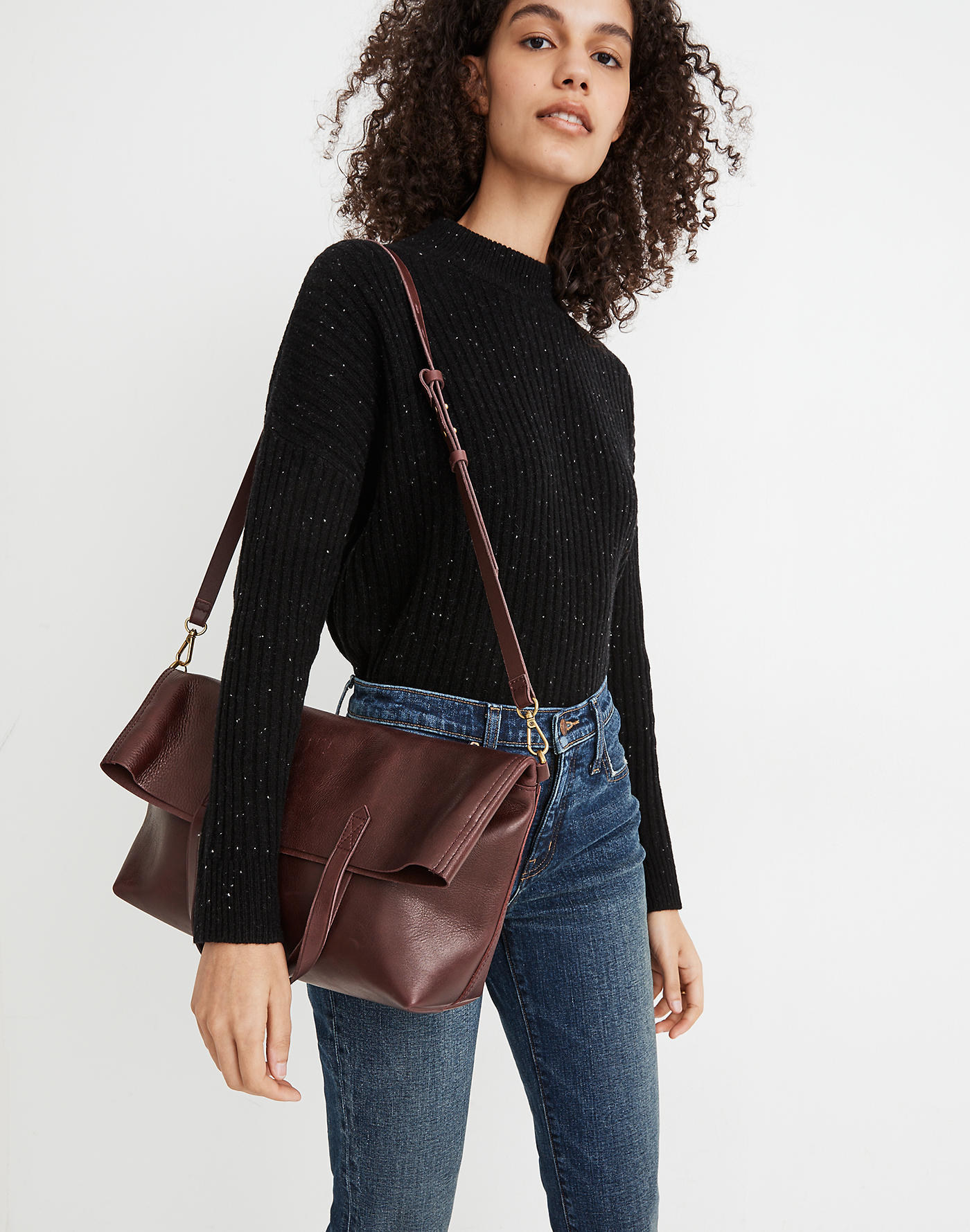 model carrying the dark red purse 