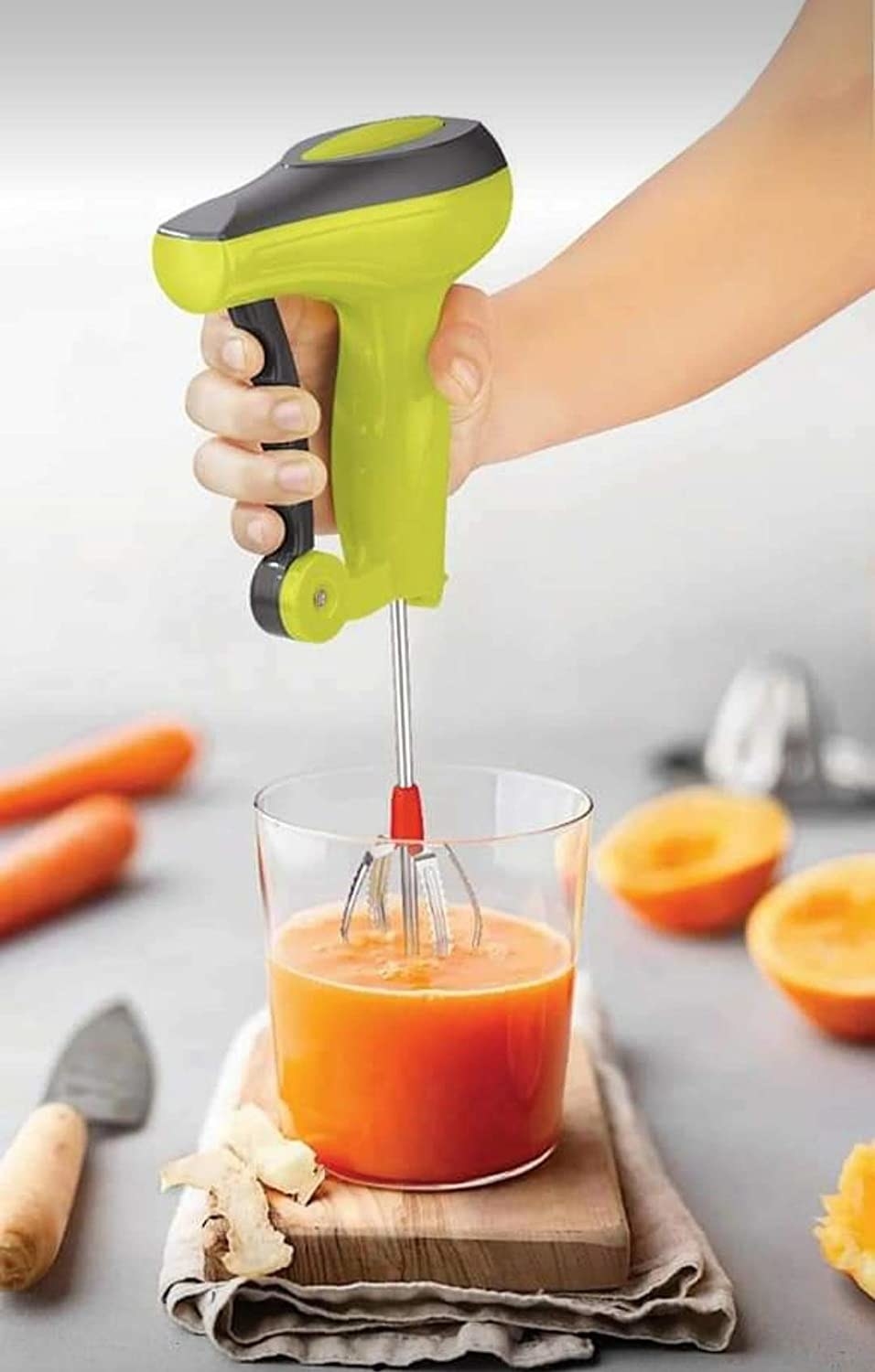 The hand-blender pictured mixing a glass of orange juice.