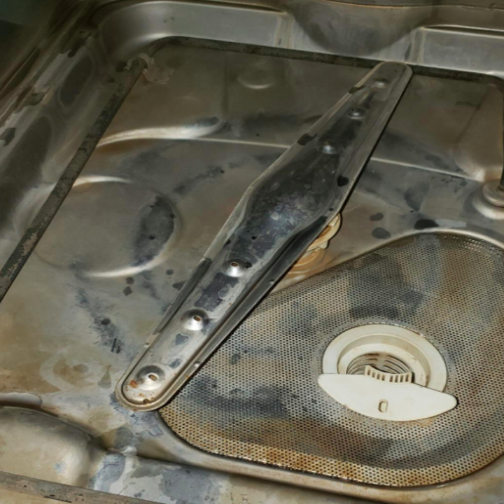 The inside of a reviewer's dishwasher looking dirty 