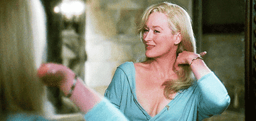 A gif of Meryl Streep tossing her long blonde hair over her shoulder