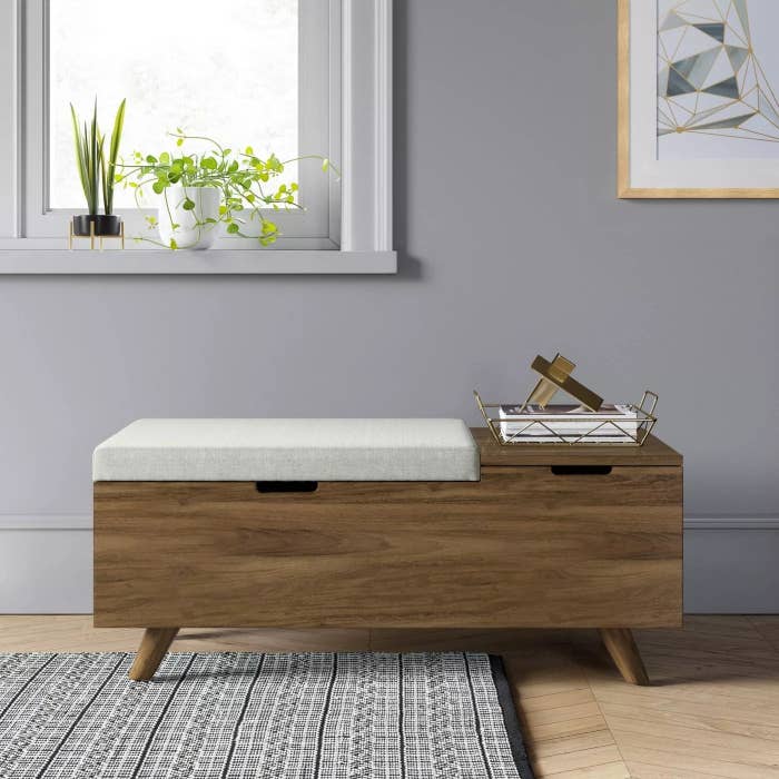 The cushioned wooden bench with opening for storage