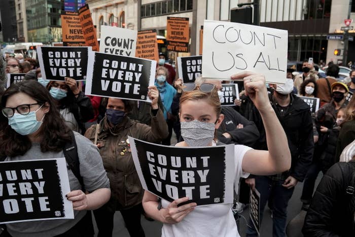 People holding &quot;count us all&quot; signs