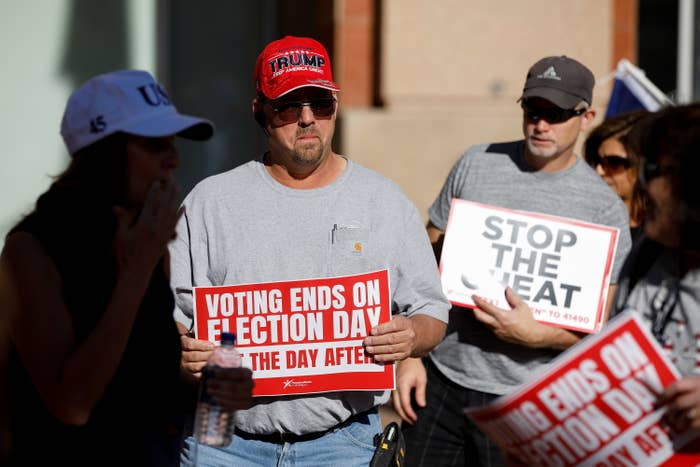 A man holding a voting ends on election day sign