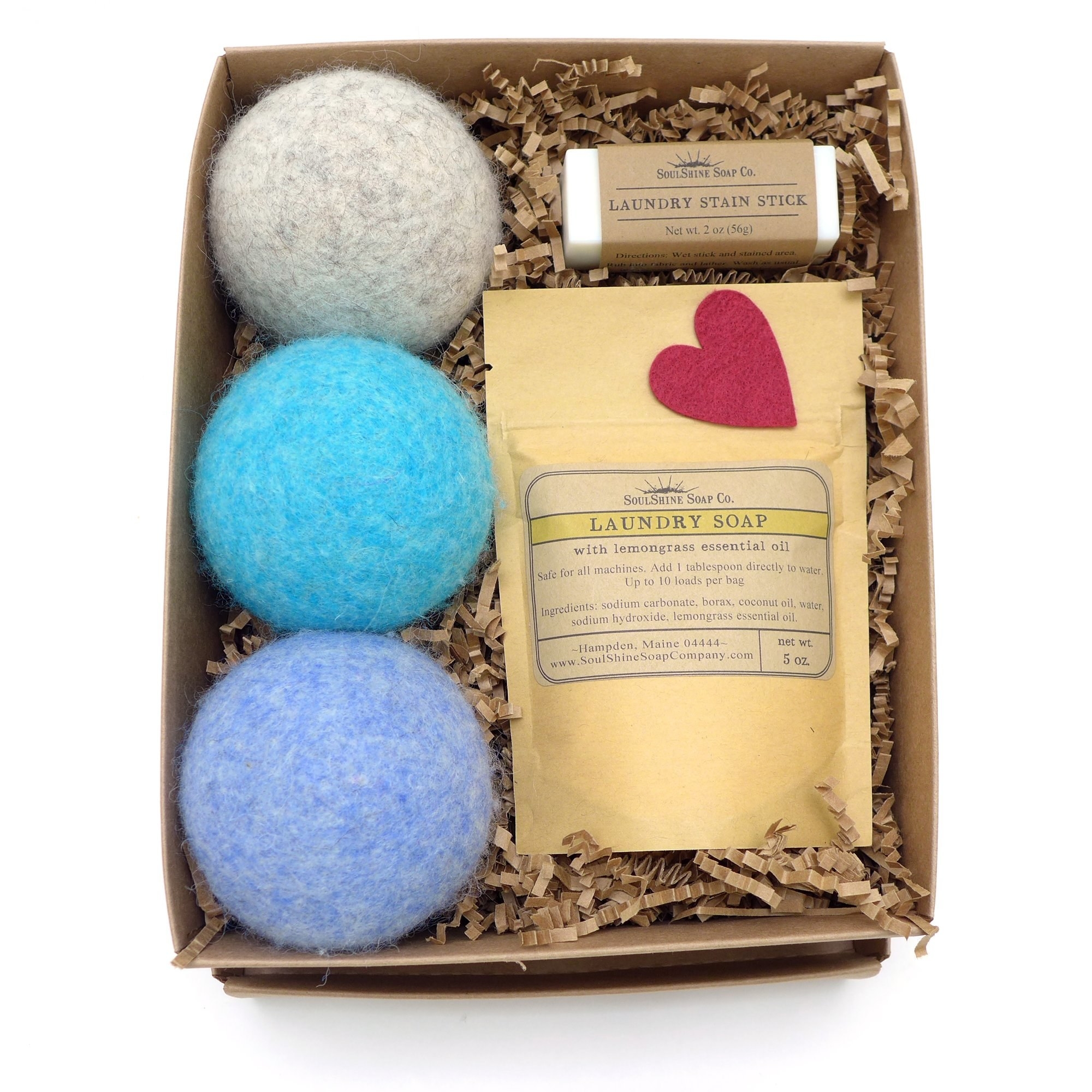 The gift box with gray, blue, and bright blue dryer balls, the soap, and the stain stick