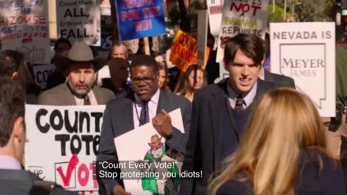 Still from a scene in which protesters yell, &quot;Count Every Vote!&quot; as they hold signs and a person responds, &quot;Stop protesting you idiots!&quot;