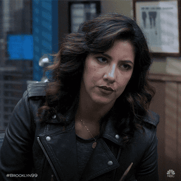 Rosa gives a deadpan look as the camera zooms into her face on Brooklyn Nine Nine