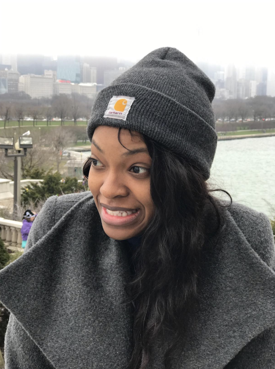 Reviewer in a gray foldover beanie with the Carhartt logo stitched in front 