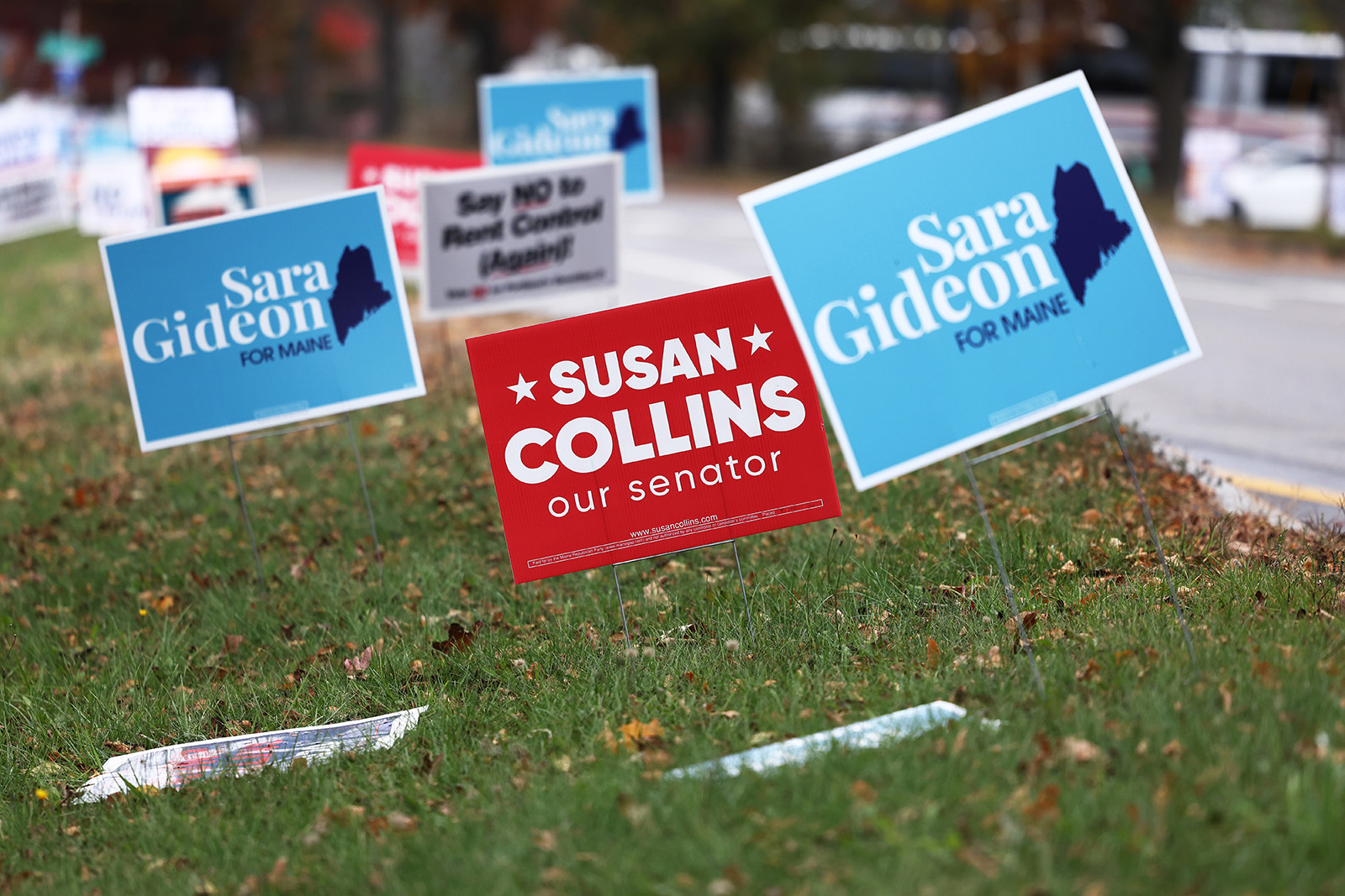 Political yard signs for Democratic candidate Sara Gideon surround one for Republican Sen. Susan Collins