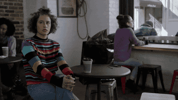 A GIF of Ilana Glazer kissing her shoulder in &quot;Broad City&quot;