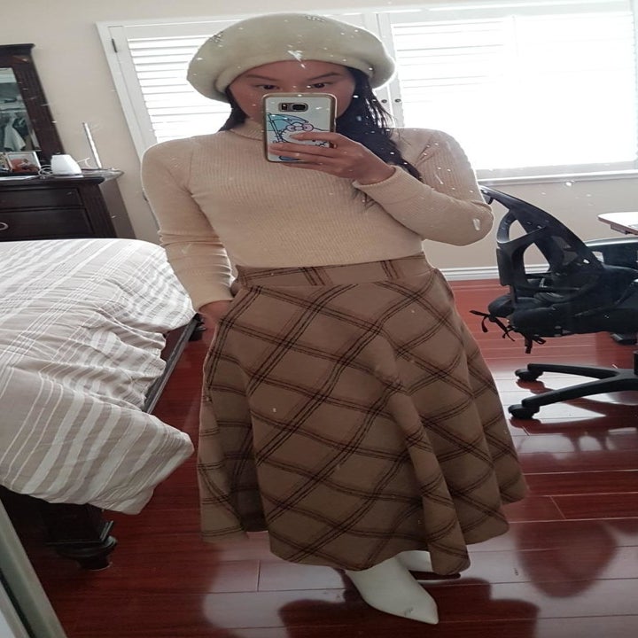 Another reviewer wearing a tan plaid version of the skirt