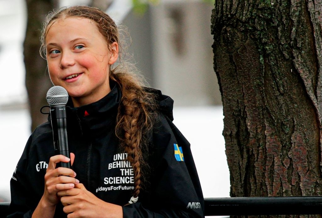 Greta Thunberg speaking into a microphone