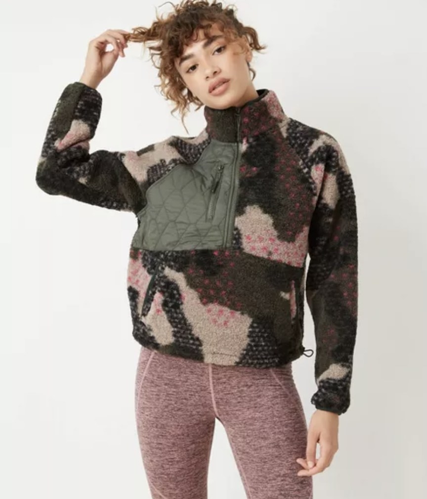 model wears camo print half zip sweatshirt 
