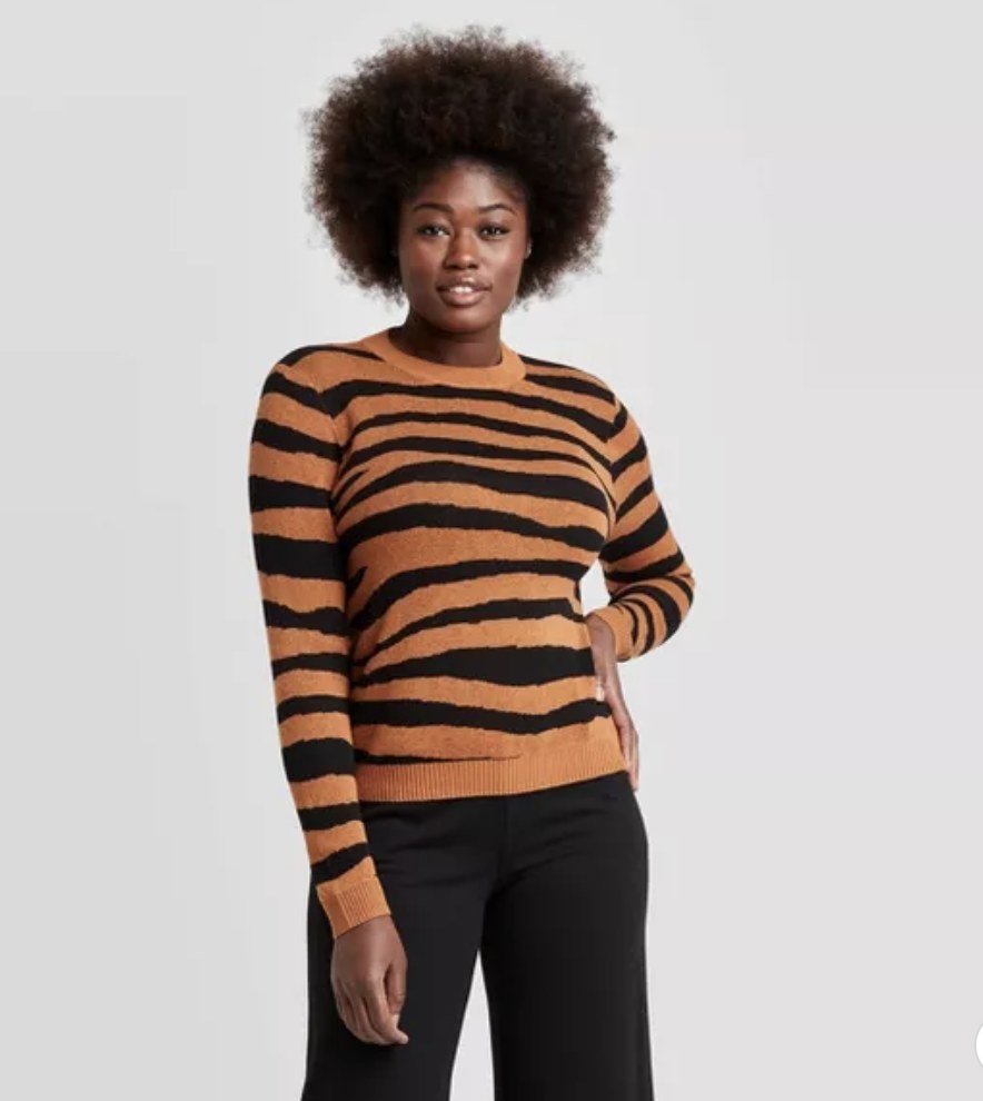 model wearing tiger-striped crewneck sweater 