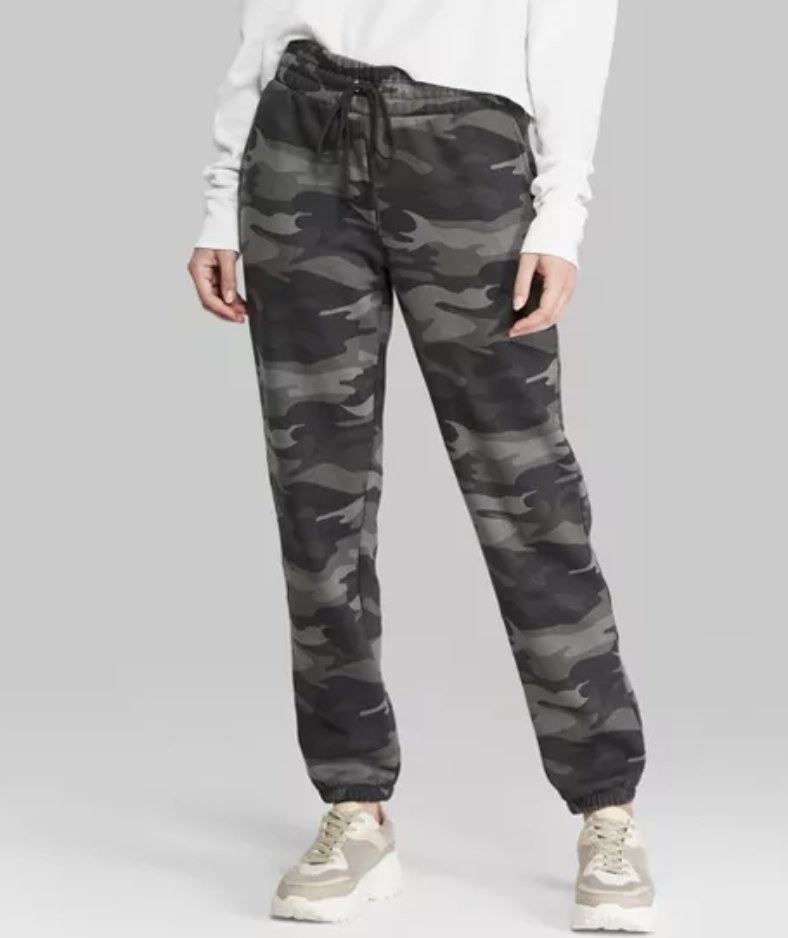 model wears camo sweatpants in a grey tone