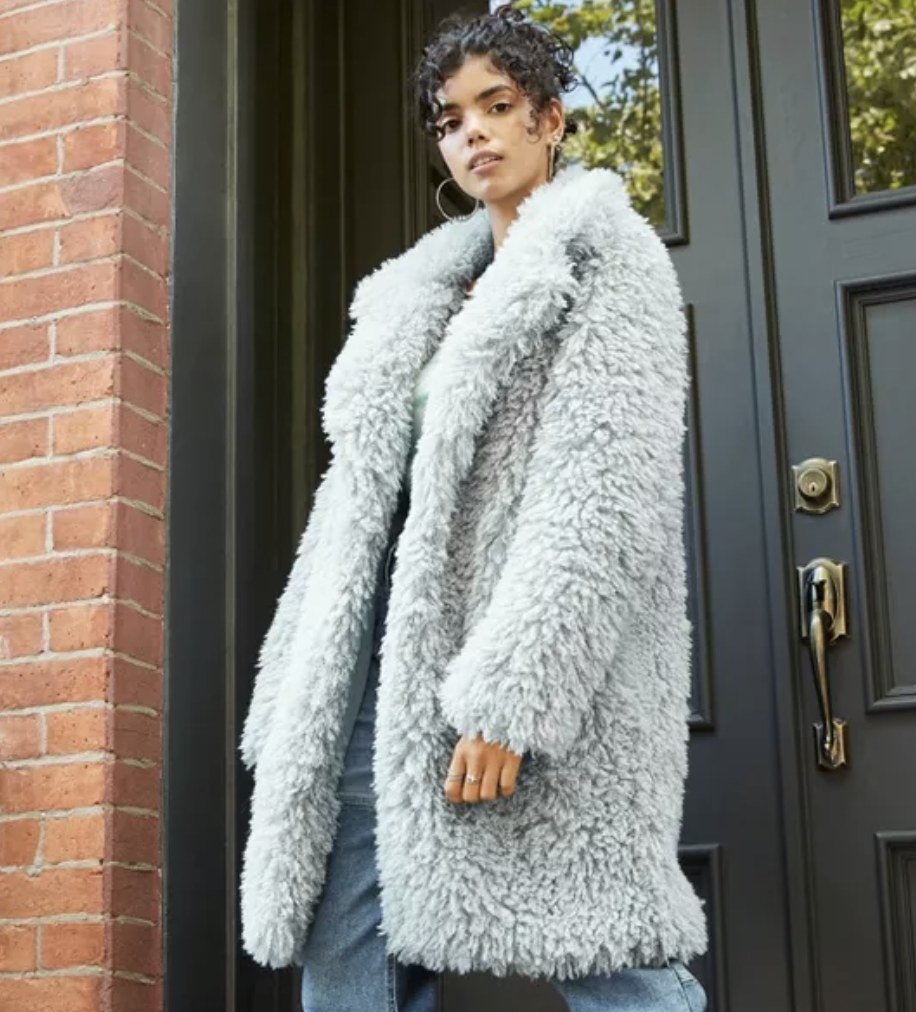 model wears light blue faux fur jacket