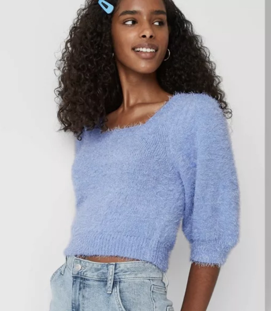 model wears blue short sleeve fuzzy cropped sweater 
