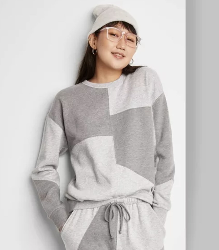 model wears patchwork gray crewneck sweatshirt 