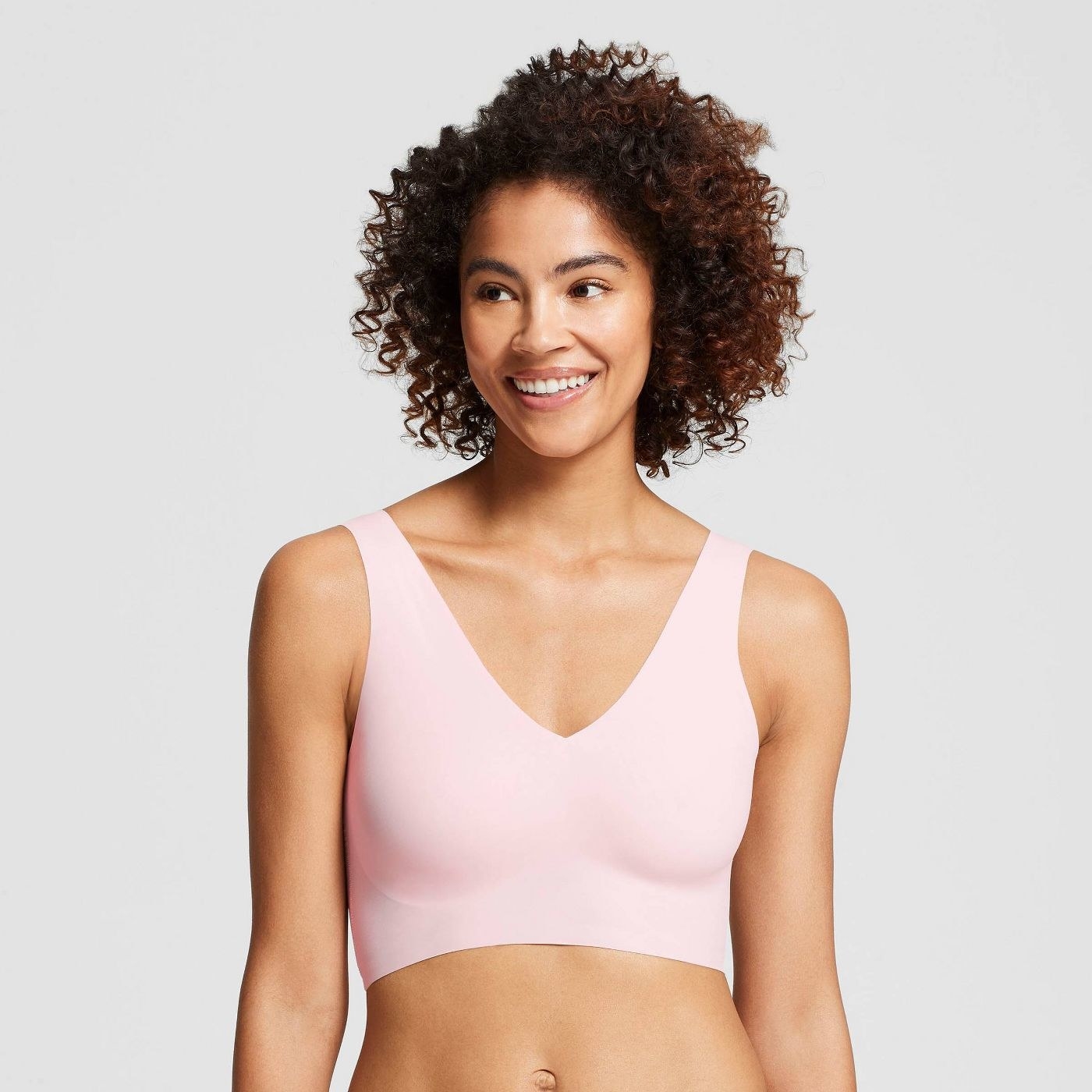 Model in pink v-neck bra 