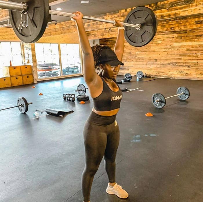 A model in the black leggings lifting a dumbell