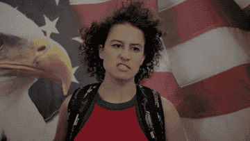 GIF of woman saluting with an American flag emblazoned with an bald eagle behind her