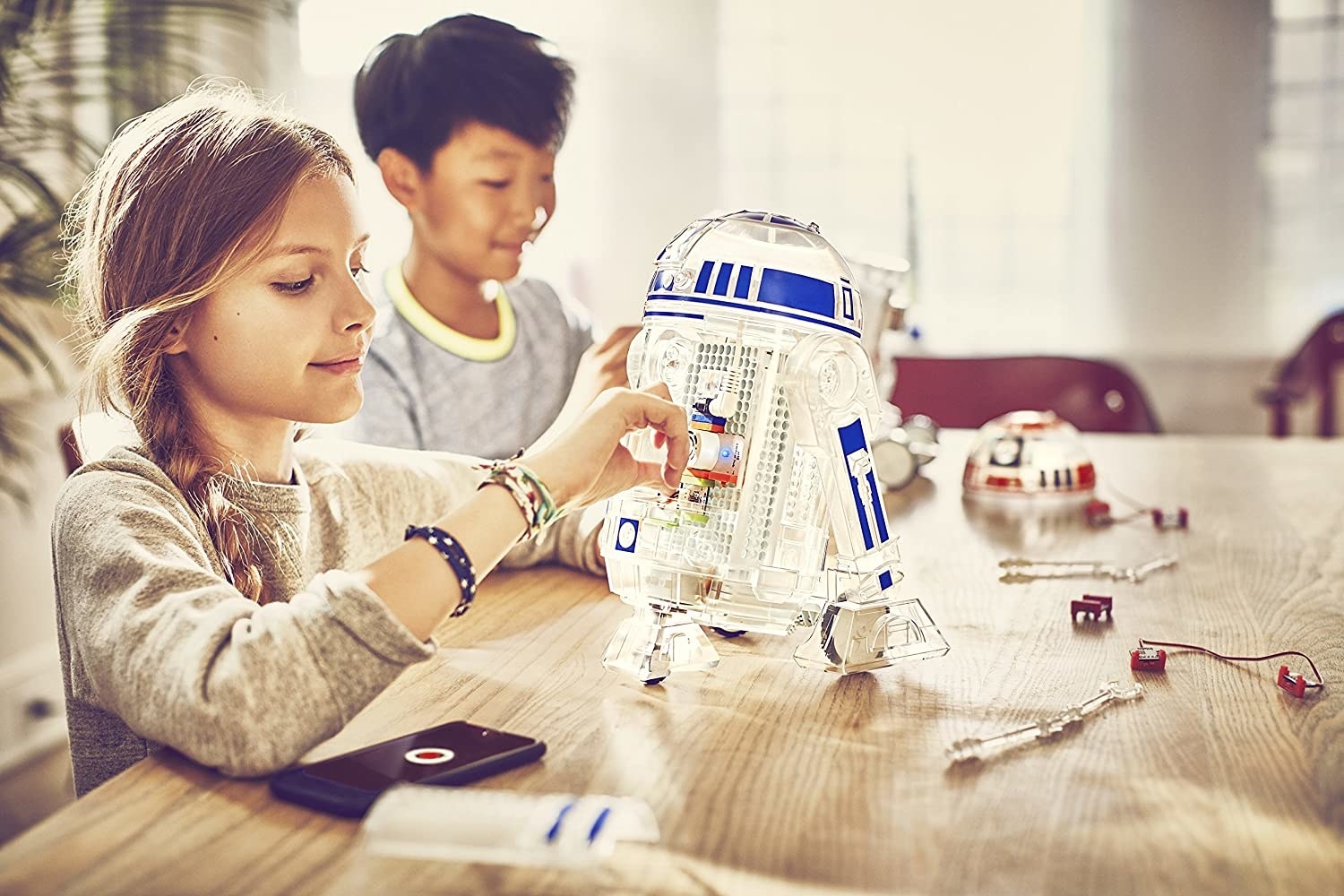 Child model building an R2-D2 droid kit