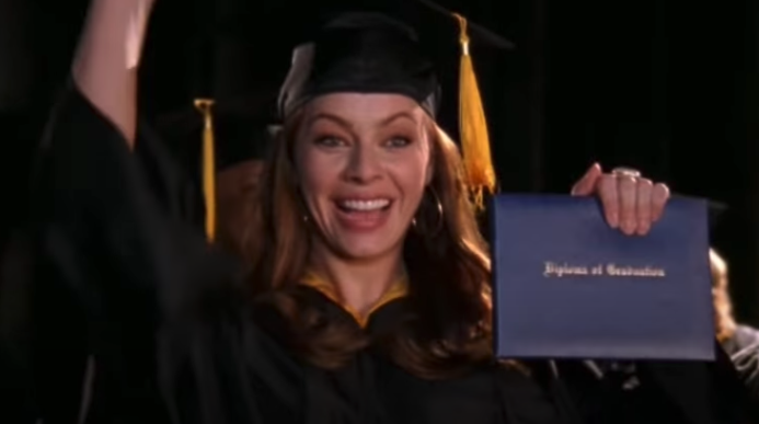 Julie graduating with a diploma in her hand